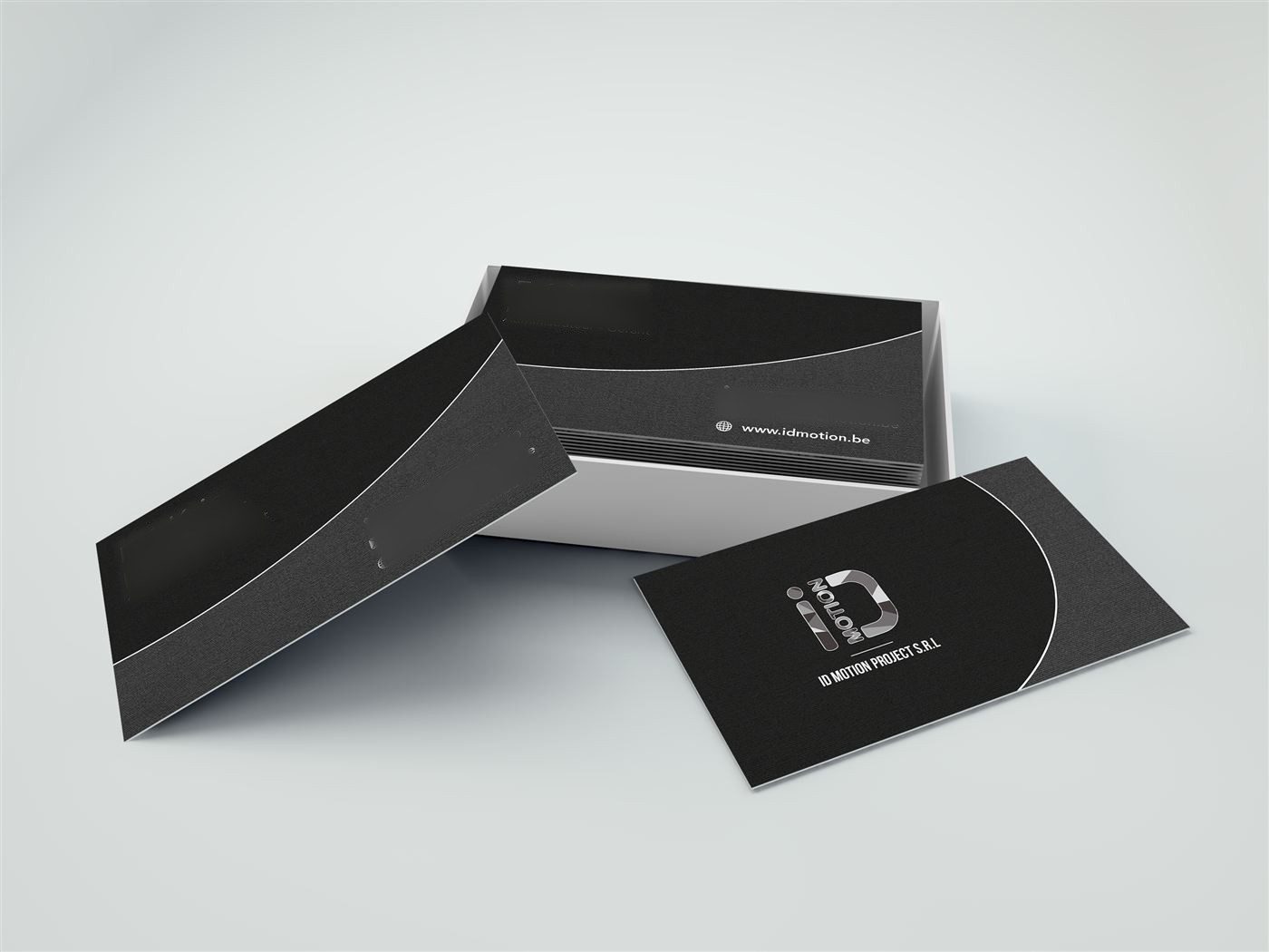 iD Motion business cards laid on a light surface