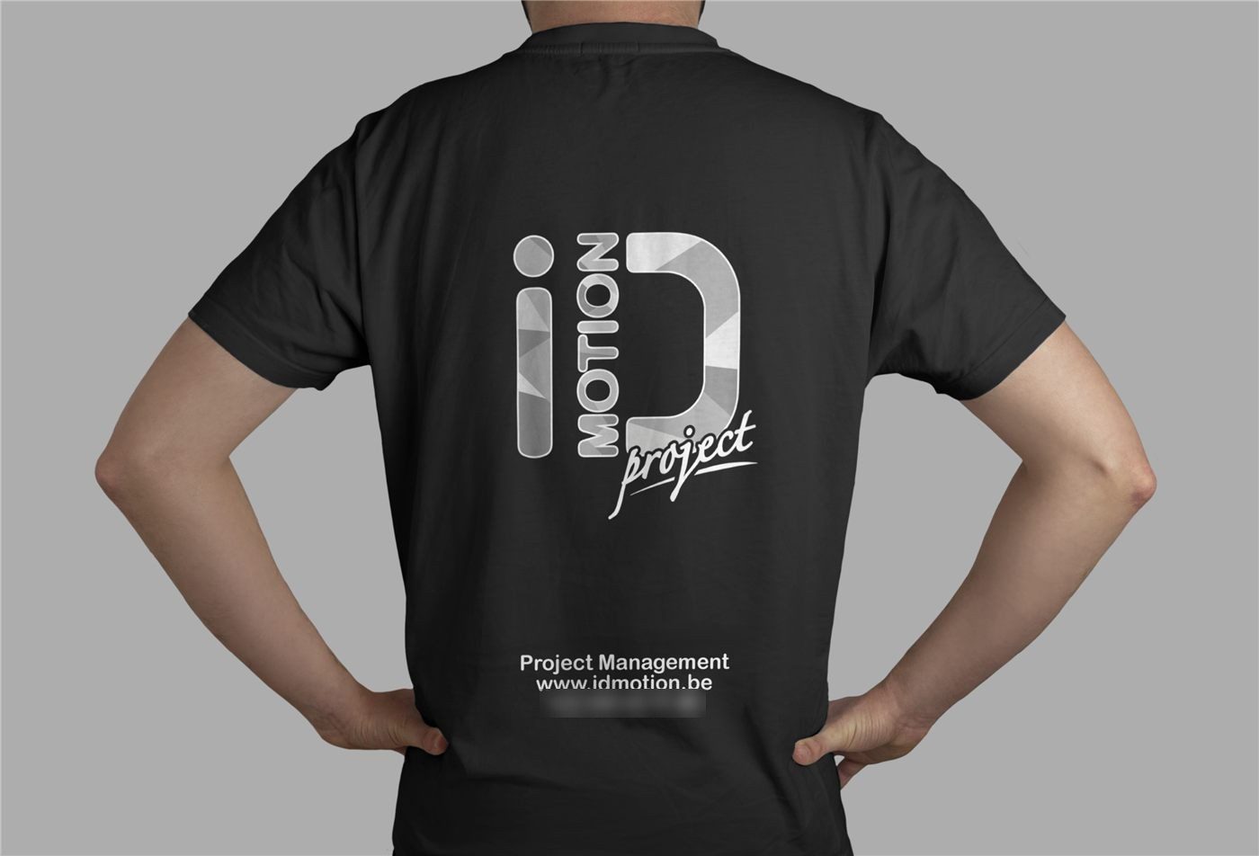 Black iD Motion t-shirt being worn, seen from the back, with the printed logo