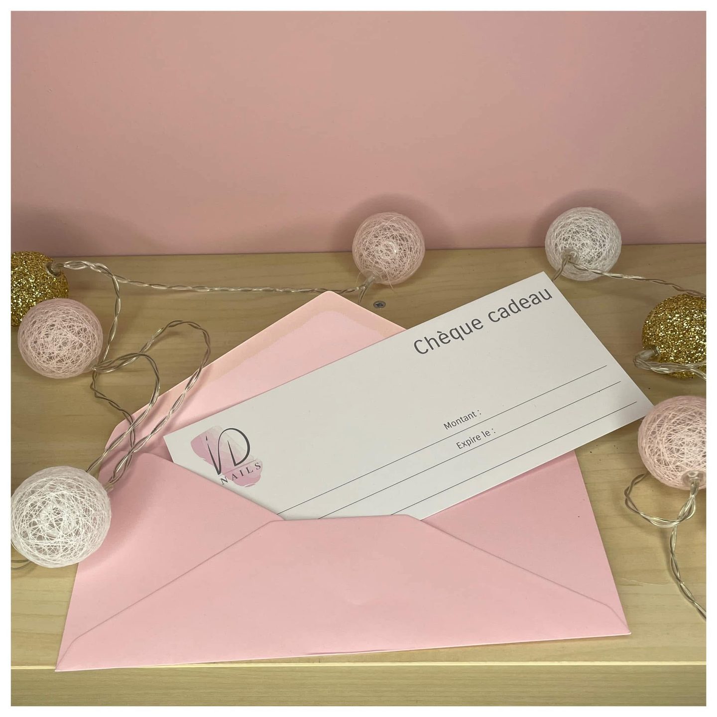 iD Nails gift voucher slipped into a pink envelope