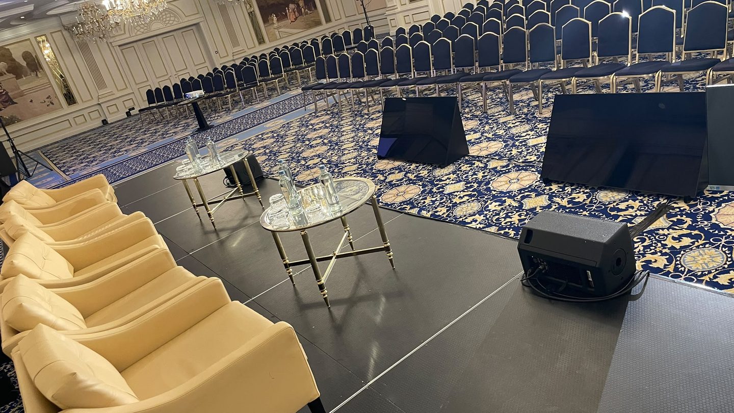 Plateau de la table ronde, avec les écrans de retour face aux intervenants et la salle prête à accueillir le public